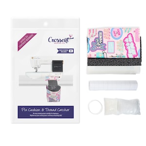 May include: A sewing kit for making a pin cushion and thread catcher. The kit includes fabric with a pink and white print with the words "Sew Cool Madness" and "Make Mend", black and white polka dot fabric, white fabric, a roll of clear interfacing, a white plastic ring, and a bag of white stuffing.