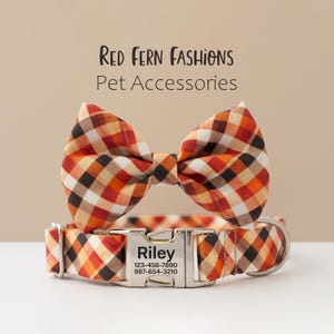 May include: A plaid dog collar and bow tie set in shades of orange, brown, and cream. The collar has a metal buckle with the name "Riley" and contact information. The text "Red Fern Fashions Pet Accessories" is at the top.