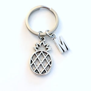 May include: Silver pineapple keychain with a silver letter M charm.