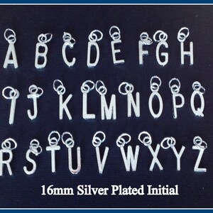 May include: Silver-plated initial charms, 16mm in size, arranged in alphabetical order from A to Z. Each letter has a small loop at the top for attaching to jewelry. The text "16mm Silver Plated Initial" is at the bottom.