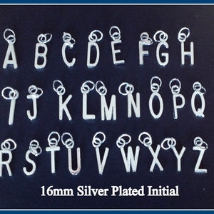 May include: Silver plated alphabet letter charms, each letter is 16mm in size. The letters are arranged in alphabetical order on a black background. 16mm Silver Plated Initial
