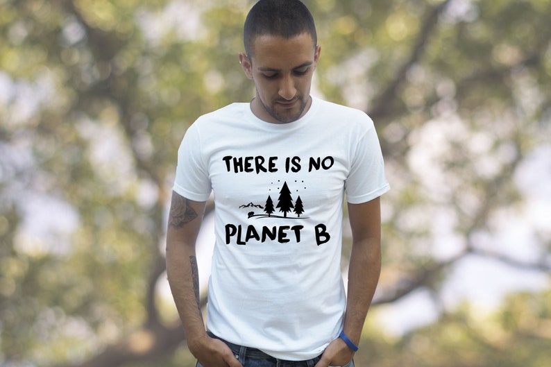 May include: White t-shirt with a black graphic that says "THERE IS NO PLANET B" with a small illustration of trees and a camper.