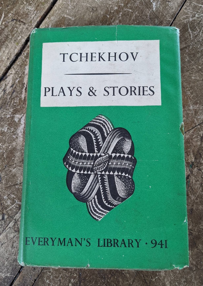 May include: A green book with the title "Tchekhov Plays & Stories" on the front cover. The book is part of the "Everyman's Library" series and has the number 941 on the cover.