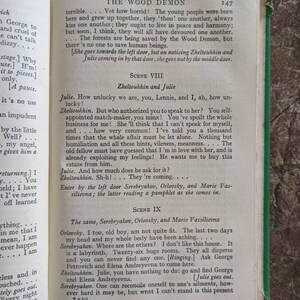 May include: A page from a vintage book titled "The Wood Demon" with text in black and white. The text describes a scene from a play with characters named Julie, Zheltoukhin, Serebryakov, Orlovsky, and Marie Vassilievna. The page number is 147.