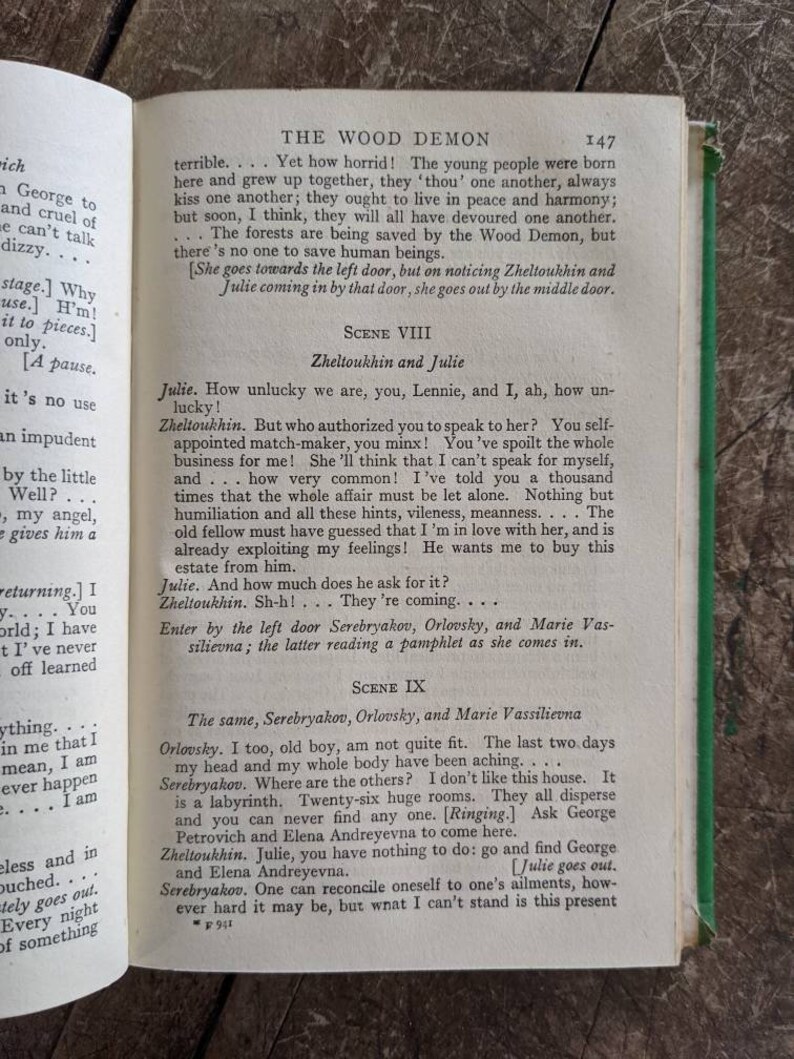 May include: A page from a vintage book titled "The Wood Demon" with text in black and white. The text describes a scene from a play with characters named Julie, Zheltoukhin, Serebryakov, Orlovsky, and Marie Vassilievna. The page number is 147.