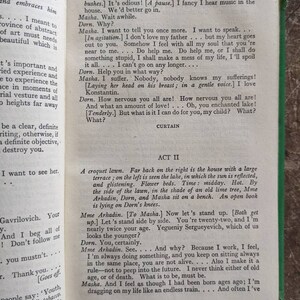 May include: A scene from a play, "The Seagull", with a group of people sitting on a bench in a garden setting. The text on the page reads, "How nervous you all are! How nervous you all are! And what an amount of love!... Oh, you enchanted lake! [Tenderly.] But what is it I can do for you, my child? What? What?"