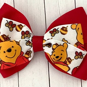 Ribbon Chick - #theribbonchicks 4” Winnie the Pooh Faux Leather Bow 6  available. #fauxleatherbows #hairbows #bows #winniethepooh  #winniethepoohbow #poohhairbow