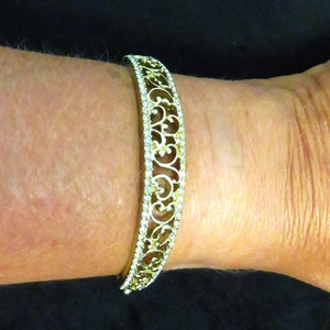 Napier Gold Tone Hinged Bracelet with a Box Clasp and Filigree Design on Front Plain on the Hinged Side of the Bracelet All Occasion Jewelry