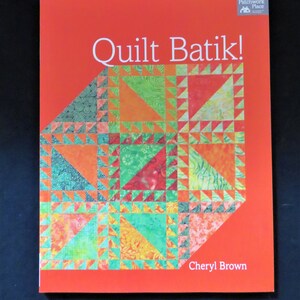 May include: A book titled "Quilt Batik!" with a colorful quilt design on the cover. The book is by Cheryl Brown and is published by The Patchwork Place.