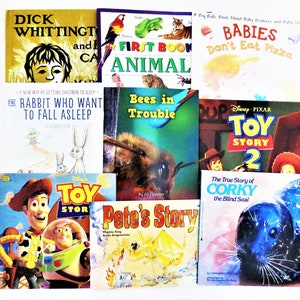May include: A collection of children's books, including titles like "Dick Whittington and Cat", "First Book Animal", and "Toy Story 2". The books feature colorful illustrations and text, with various themes.