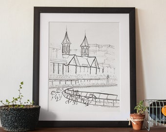 May include: Black and white line drawing of a racetrack with a grandstand and horses running around the track. The drawing is framed in a black frame and hanging on a white wall.