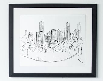 May include: A black and white line drawing of a city skyline with trees and a road in the foreground. The drawing is framed in a black frame and hanging on a white wall.