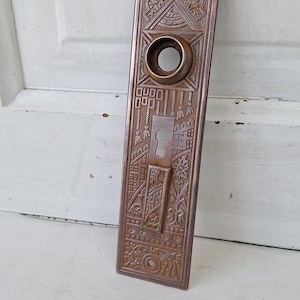 Eastlake Bronze Plate with Double Keyhole, Ceylon Pattern Entry Door Knob Backplate