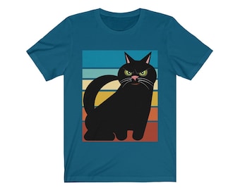 May include: A teal blue t-shirt with a black cat silhouette against a retro sunset background. The cat has green eyes and a pink nose.