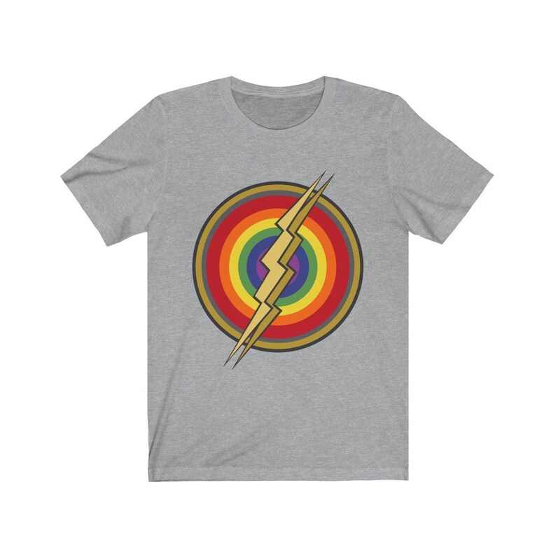 May include: A grey t-shirt with a rainbow and lightning bolt design. The design is in the center of the shirt and is a stylized version of the Flash logo.