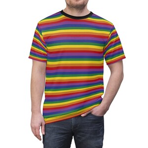 May include: A short-sleeved t-shirt with a rainbow striped pattern. The shirt has a black crew neck.
