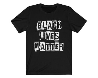 May include: Black t-shirt with a white graphic that says "Black Lives Matter" in a distressed, torn-paper style.