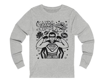 May include: A gray long-sleeve shirt with a black and white illustration of a superhero with the text "SUPER DAD" and comic book style speech bubbles with the words "BANG!", "SMASH!", "ZAP!", "HALT!", "DOING", "POW!" and stars.