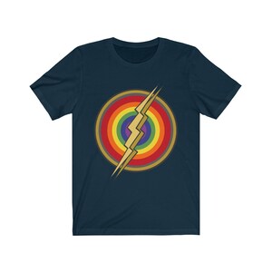 May include: A navy blue t-shirt with a rainbow and lightning bolt design. The lightning bolt is gold and the rainbow is in the colors of the pride flag.