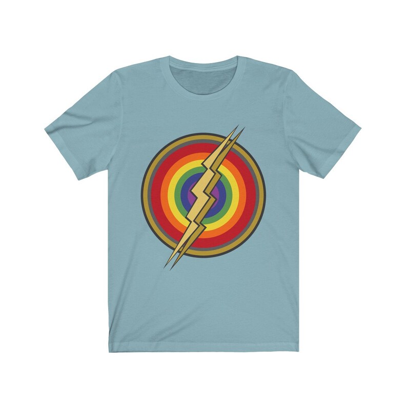 May include: A light blue t-shirt with a rainbow circle and a gold lightning bolt graphic.