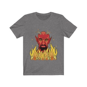May include: A gray t-shirt with a red devil head illustration surrounded by orange flames. The devil has a black beard and a serious expression.