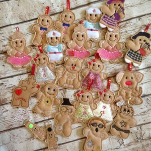 May include: A collection of 20 felt gingerbread ornaments in various designs, including a nurse, a doctor, a ballerina, a cat, a dog, a reindeer, a snowman, and a gingerbread person wearing sunglasses. The ornaments are all brown and feature various colorful details.