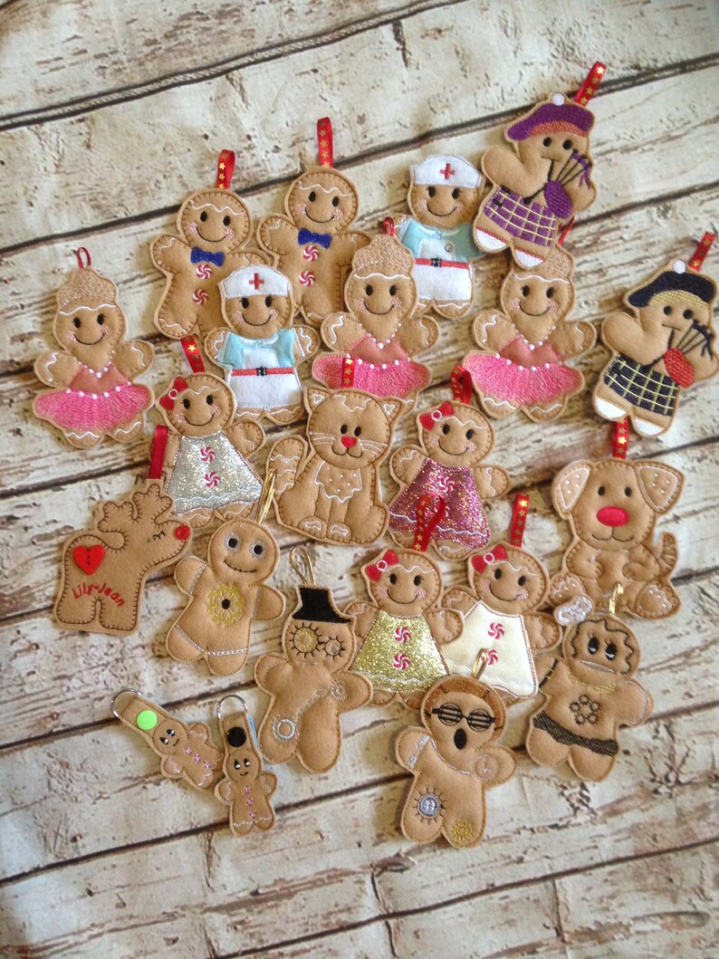 May include: A collection of 20 felt gingerbread ornaments in various designs, including a nurse, a doctor, a ballerina, a cat, a dog, a reindeer, a snowman, and a gingerbread person wearing sunglasses. The ornaments are all brown and feature various colorful details.