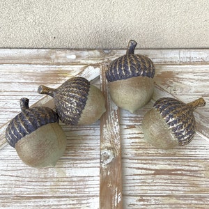 resin acorn table decor with green patina finish and brown with antique gold top with stem for fall table decor or mantel decor. Thanksgiving table decor. artificial acorn fall resin acorns pairs well with mushrooms. Fall basket filler wood bowl