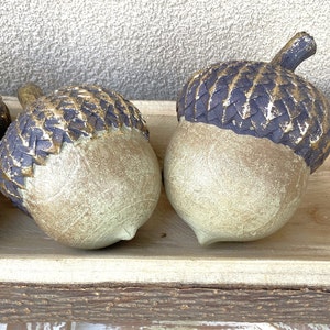 resin acorn table decor with green patina finish and brown with antique gold top with stem for fall table decor or mantel decor. Thanksgiving table decor. artificial acorn fall resin acorns pairs well with mushrooms. Fall basket filler wood bowl