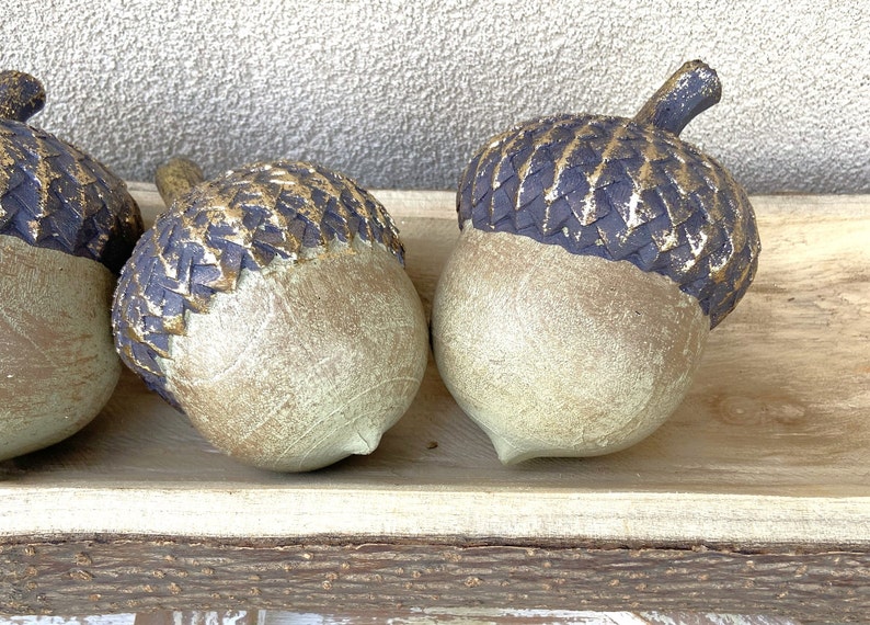 resin acorn table decor with green patina finish and brown with antique gold top with stem for fall table decor or mantel decor. Thanksgiving table decor. artificial acorn fall resin acorns pairs well with mushrooms. Fall basket filler wood bowl