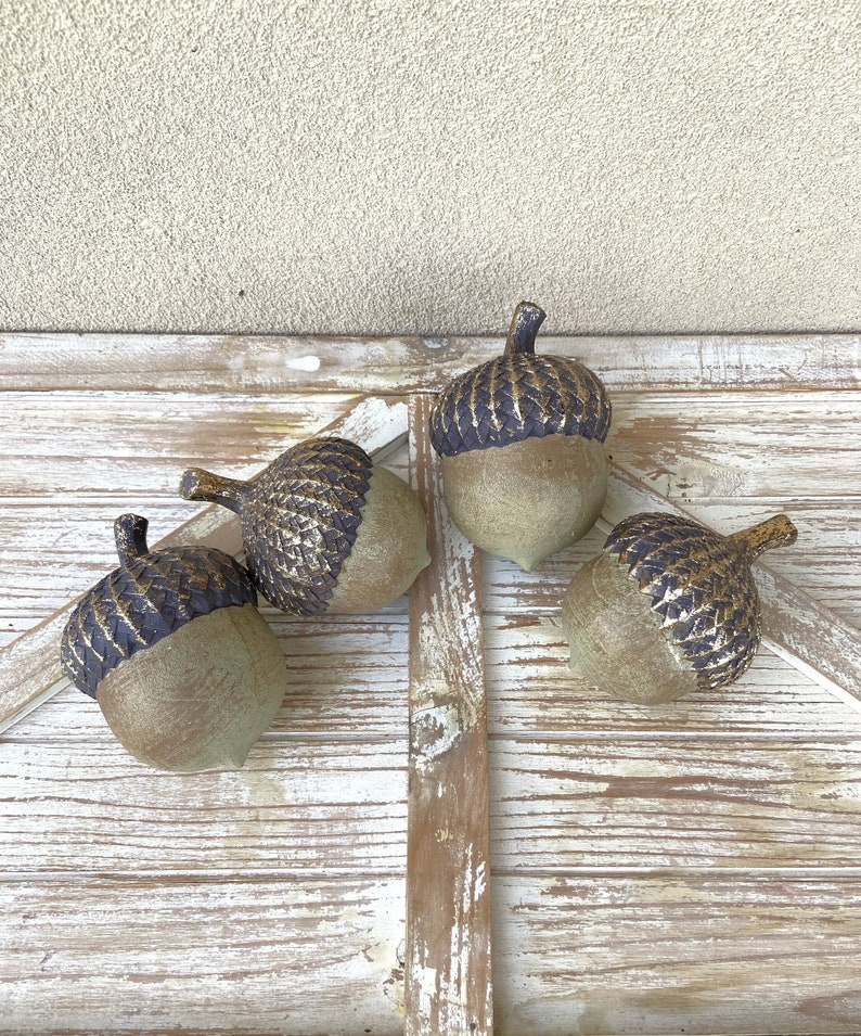 resin acorn table decor with green patina finish and brown with antique gold top with stem for fall table decor or mantel decor. Thanksgiving table decor. artificial acorn fall resin acorns pairs well with mushrooms. Fall basket filler wood bowl