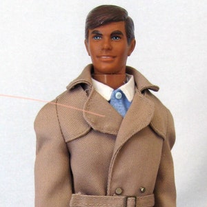 May include: A tan trench coat with a brown belt and a brown leather bag. The coat has a button closure and a collar.