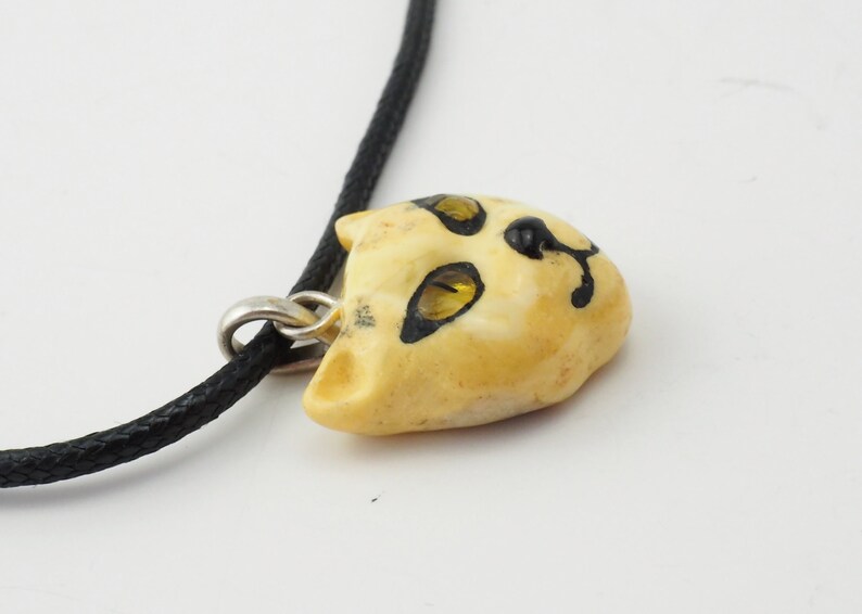 Unique Artisan butterscotch amber carved cat face pendant black chord necklace