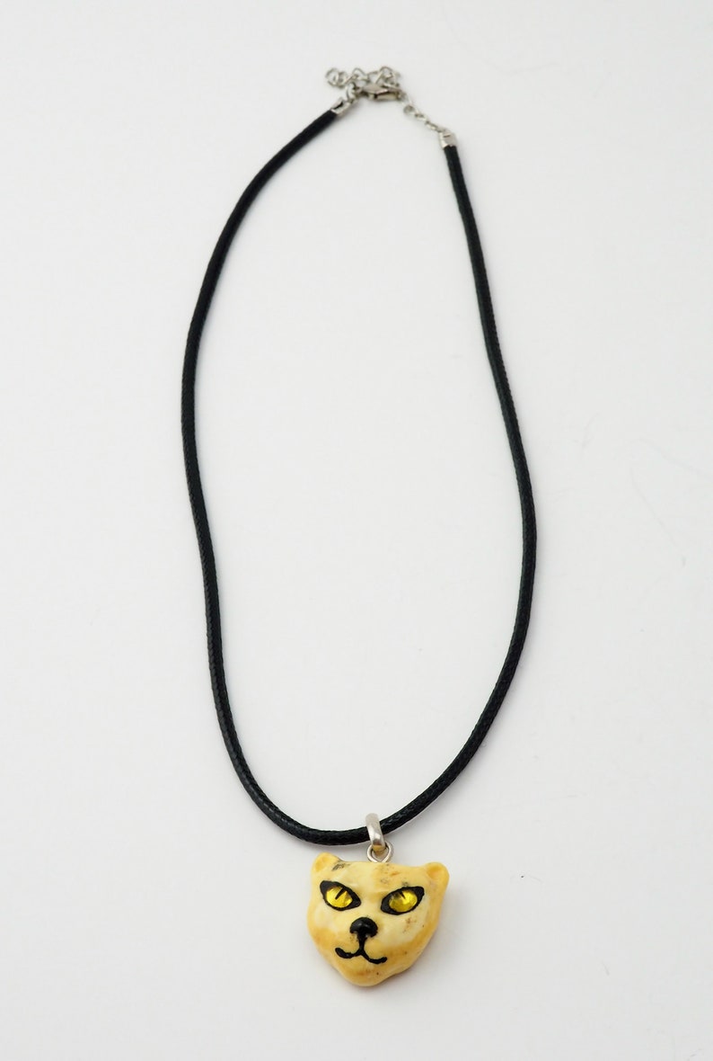Unique Artisan butterscotch amber carved cat face pendant black chord necklace