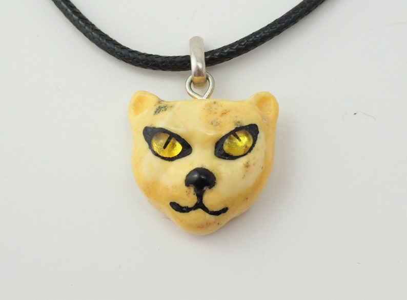 Unique Artisan butterscotch amber carved cat face pendant black chord necklace