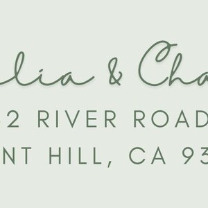 May include: A light green invitation or card with the names "Amelia & Charles" in elegant script. Below, the address reads "3232 River Road, Pleasant Hill, CA 93423." Decorative green bunting adorns the top corners.