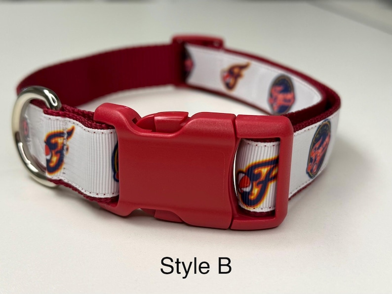 May include: Red and white dog collar with a red plastic buckle and a silver metal D-ring. The white ribbon features a repeating pattern of a team logo. The text "Style B" is at the bottom.