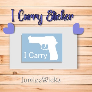 May include: A blue and white sticker with a silhouette of a handgun and the text "I Carry". The sticker is on a wooden background with two purple hearts.