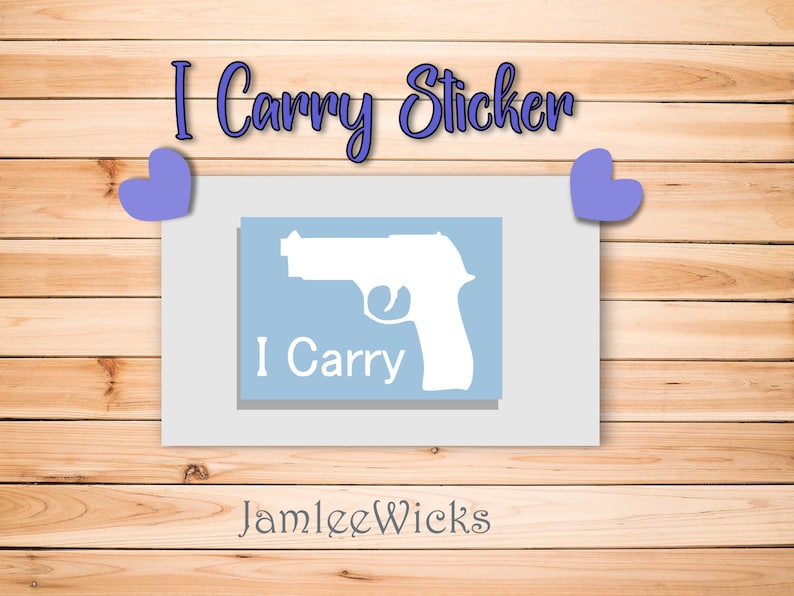 May include: A blue and white sticker with a silhouette of a handgun and the text "I Carry". The sticker is on a wooden background with two purple hearts.