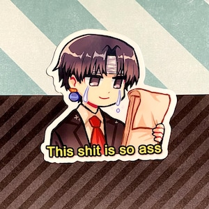 May include: A sticker featuring an anime-style character with purple hair, a bandage on their head, and tears. The character is holding a scroll and wearing a suit with a red tie. Text on the sticker reads "This shit is so ass."