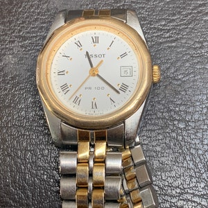 Montre bicolore vintage pour femme TISSOT PR100 bicolore avec cadran blanc et date