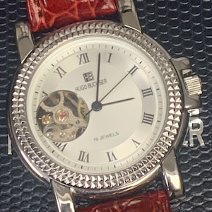 Unusual Vintage Men s Hugo Buchser Gents Mechanical 19 jewels Watch visible balance with Exhibition Back