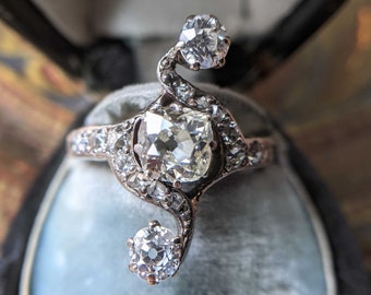 Circa 1890s Antique Art Nouveau Three Stone Cushion Old Mine Cut Diamond Engagement or Statement Ring in 18K Gold and Silver
