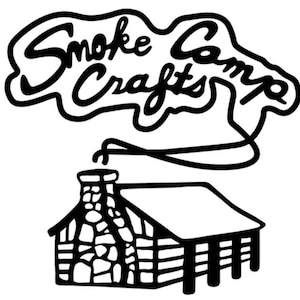 May include: Black and white illustration of a cabin with smoke coming from the chimney. The text "Smoke Camp Crafts" is written in a stylized font above the cabin.