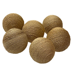 May include: A collection of five spherical objects, each wrapped in a light brown, natural fiber rope. The spheres are arranged in a cluster, showcasing a consistent, tightly coiled texture across the surface of every individual round item.
