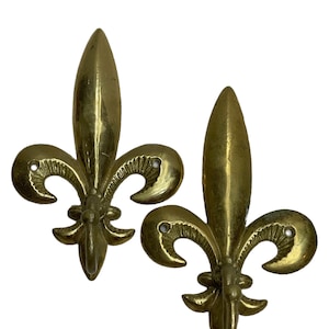 Pair of brass fleur de lis hooks