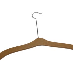 May include: A brown, flat-profile clothes hanger with a smooth, matte finish and a curved, ergonomic shape. It features a slender, silver-toned metal hook at the top, designed for hanging garments securely in a closet or on a display rack.