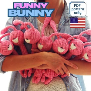 May include: A woman holds a group of seven pink crocheted bunny toys. The toys have long ears and are all facing forward. The text "FUNNY BUNNY" is in the top left corner of the image. The text "PDF pattern only" is in the top right corner of the image.