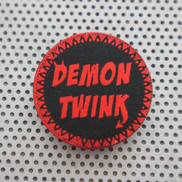 Demon Twink pin 1.5" pinback button. Handmade gay man queer typography badge LGBTQ print in metallic red foil on black Shiny flair for Pride