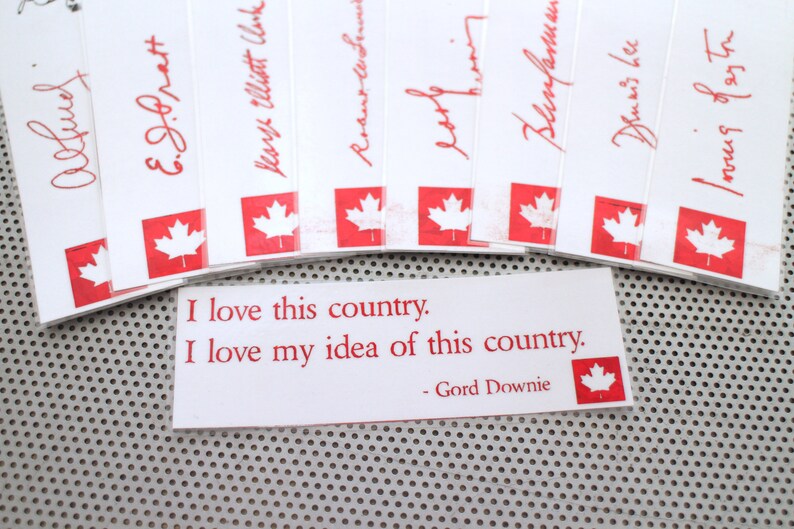 May include: A white card with red text and a red Canadian flag. The text reads "I love this country. I love my idea of this country. - Gord Downie"